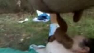 Guy pooping on girl's face outdoor