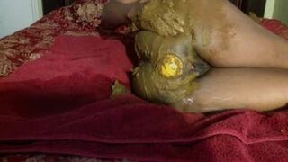 Wild amateur ebony scat girl enjoys playful solo session with poop, pee, fisting, and orange insertion