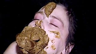 Kinky dude dumps his massive steaming turd right on this hot brunette's pretty face